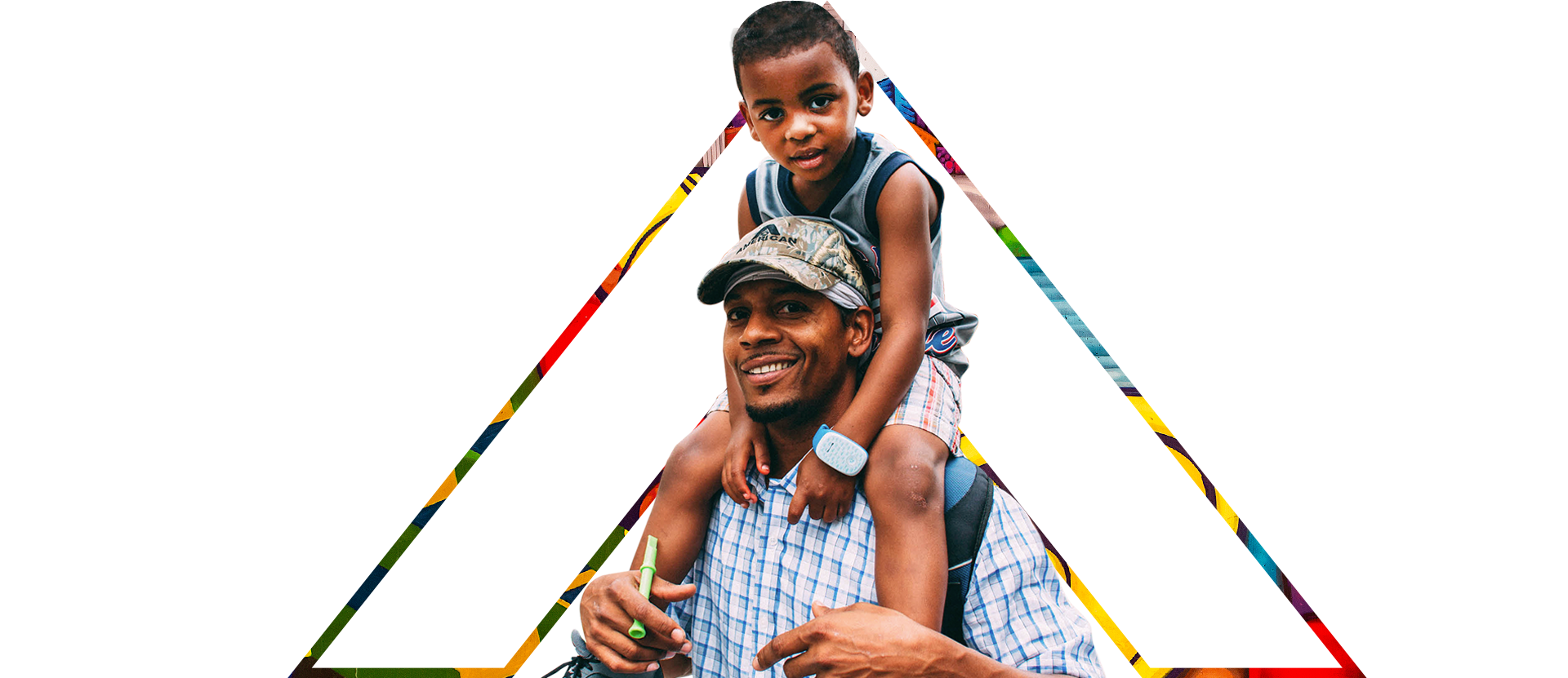An African-American man smiling with his son on top of his shoulders